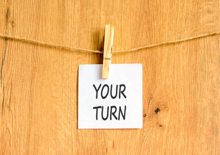Your turn words symbol. Concept words Your turn on beautiful white paper on wooden clothespin. Beautiful wooden background. Business your turn motivational support concept. Copy space.