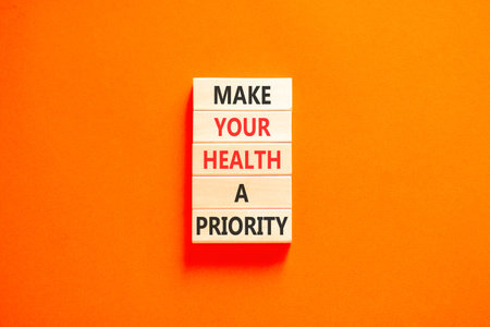 Make your health a priority symbol. Concept words Make your health a priority on beautiful wooden blocks. Beautiful orange background. Medical make your health a priority concept. Copy space.
