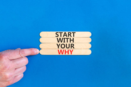 Start with your why words symbol. Concept words Start with your why on beautiful wooden sticks. Beautiful blue background. Businessman hand. Business start with your why concept. Copy space.