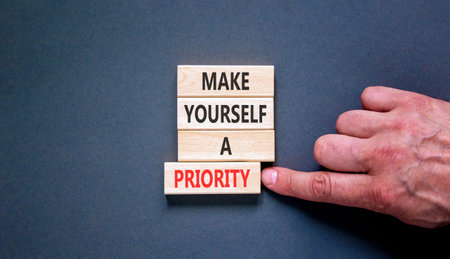 Make yourself a priority symbol. Concept words Make yourself a priority on beautiful wooden blocks. Beautiful grey background. Business psychological make yourself a priority concept. Copy space.