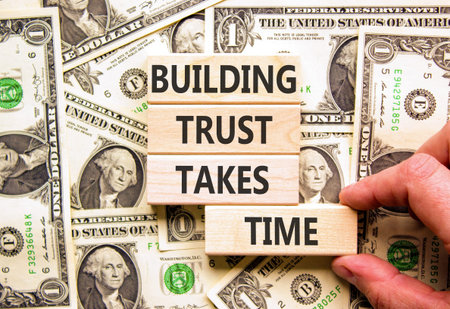 Building trust takes time words symbol. Concept words Building trust takes time on beautiful wooden blocks. Beautiful dollar bills background. Business building trust takes time concept. Copy space.