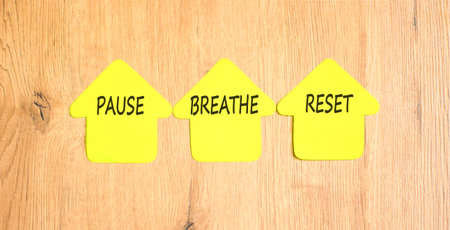 Pause breathe reset symbol. Concept words Pause breathe reset on beautiful yellow paper houses. Beautiful wooden background. Business support motivational and pause breathe reset concept. Copy space.