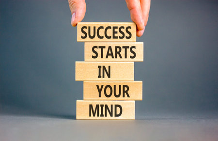 Success starts in your mind symbol. Concept words Success starts in your mind on beautiful wooden blocks. Beautiful grey background. Business and success starts in your mind concept. Copy space.
