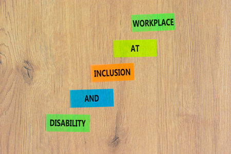 Disability and inclusion symbol. Concept words Disability and inclusion at workplace on beautiful colored papers. Beautiful wooden background. Disability and inclusion at workplace concept. Copy space