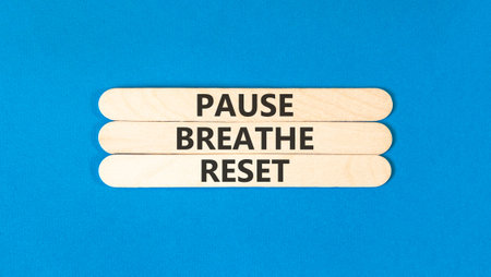 Pause breathe reset words symbol. Concept words Pause breathe reset on beautiful wooden sticks. Beautiful blue background. Business support motivational and pause breathe reset concept. Copy space.