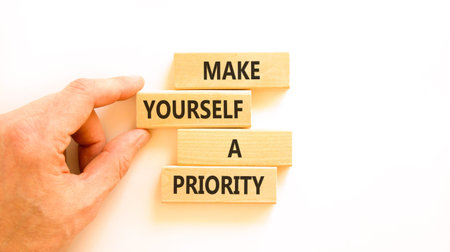 Make yourself a priority symbol. Concept words Make yourself a priority on beautiful wooden blocks. Beautiful white background. Business psychological make yourself a priority concept. Copy space.