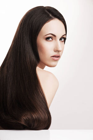 Closeup portrait of female with beautiful brown hair posing in studio, elegant makeup, natural hairstyleの写真素材