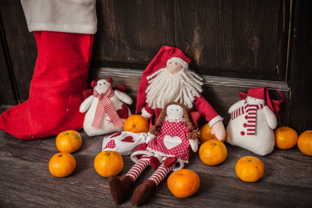 Hand made textile Christmas toys decoration. Winter Holidays concept. Vintage style, over wood background.の写真素材