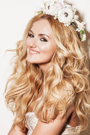 Portrait of affectionate blond woman. Beautiful bride with wedding makeup, hairdo and wedding decorations. Wedding ideas and bridal style.の写真素材