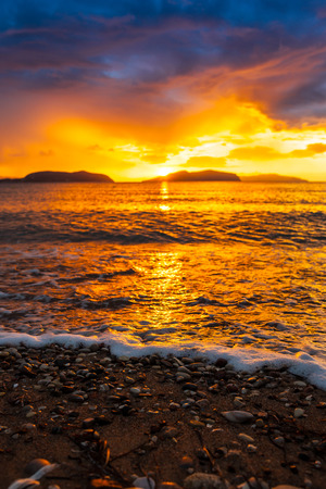 Beautiful colorful sunset on the beach. Tropical paradise resort at the seaside.の写真素材