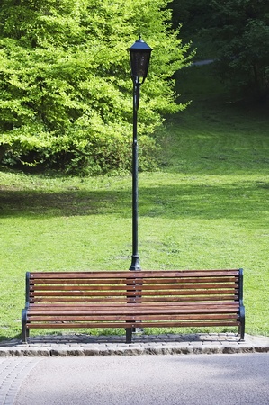 Bench and street lamp in the parkの写真素材
