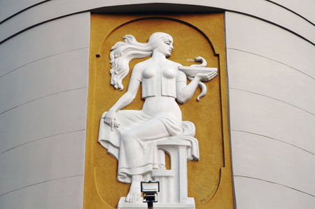 LVIV, UKRAINE - MARCH 13: The bas-relief above the entrance to the old pharmacy - the girl with the symbol of medicine on March 13, 2011 in Lviv, Ukraine. Author - R.E. Olensk, 1980.のeditorial素材