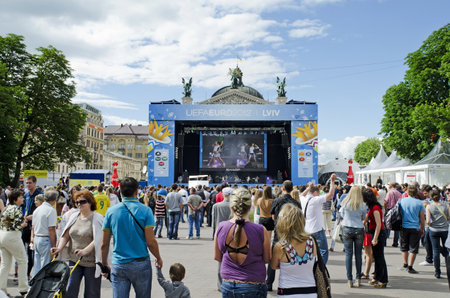 LVIV, UKRAINE - JUNE 13, 2012: In the Lvov Fan-zone on Euro-2012, before the football match Denmark-Portugal, the audience entertained an unknown show-ballet.のeditorial素材