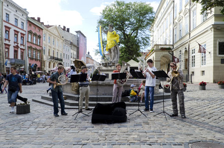 LVIV, UKRAINE - JUNE 13: Street musicians in the center of Lvov entertain tourists, who came to the UEFA EURO-2012 on June 13, 2012 in Lviv, Ukraine. In Lviv are held football matches EURO-2012.のeditorial素材