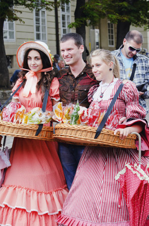 LVIV, UKRAINE - JUNE 13: In the center of Lviv, especially for tourists, working candy sellers, dressed in retro clothing on June 13, 2012 in Lviv, Ukraine. のeditorial素材
