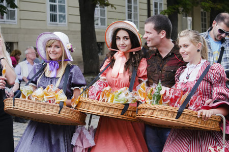LVIV, UKRAINE - JUNE 13: In the center of Lviv, especially for tourists, working candy sellers, dressed in retro clothing on June 13, 2012 in Lviv, Ukraine. のeditorial素材