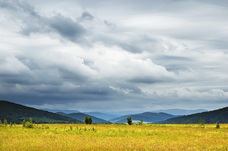 Landscape - dramatic clouds and mountainsの写真素材