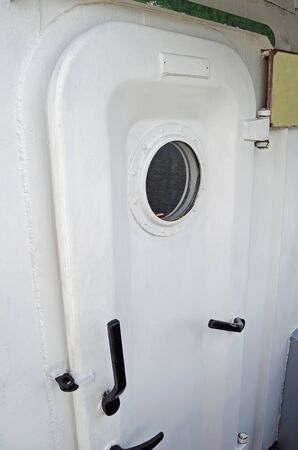 Ship door with a portholeの写真素材