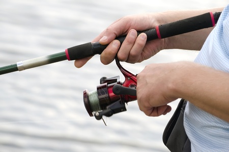 Fisherman holding a spinning closeupの写真素材