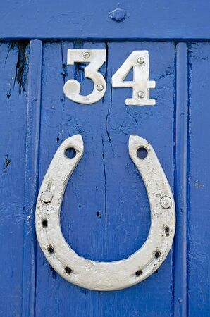 Horseshoe on the blue doorの写真素材