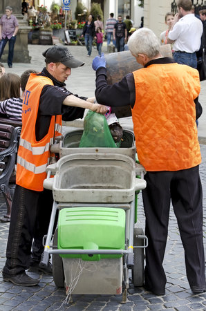 LVOV, UKRAINE - MAY 04: Lvov city administration announced that during Euro-2012, cleanliness of streets in the center of Lvov will be maintained at all times on May 04, 2012 in Lvov, Ukraine. In the photo - unknown janitors.のeditorial素材
