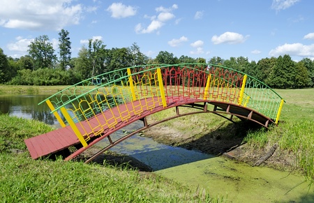 Picturesque arched bridge over a pondの写真素材