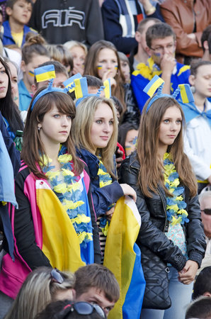 LVOV, UKRAINE - JUNE 15: A lot of young fans came to the fan zone in Lvov to watch a football match Ukraine - France in the Euro 2012 on June 15, 2012 in Lviv, Ukraine. In the photo - young girls watching the match.のeditorial素材