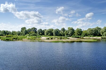 Beautiful rural landscape - scenic river against the sky with cloudsの写真素材