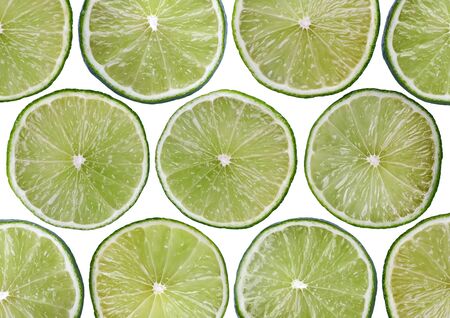 Food background - Sliced fresh lime, isolated over whiteの写真素材