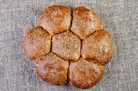 Bread with sesame seeds close-up, lying on sacking