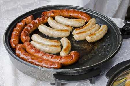Tasty sausage in a skillet close-upの写真素材