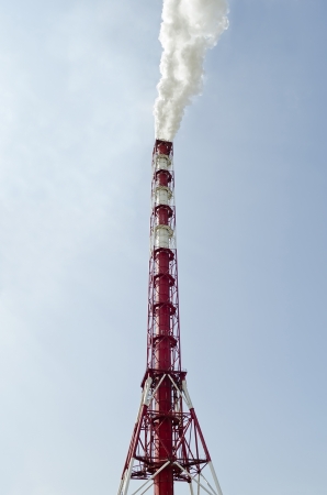 Industrial background - high fuming factory chimney close-upの写真素材