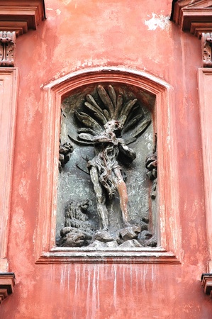 Old sculpture on a red building in Lvov, Ukraineの写真素材