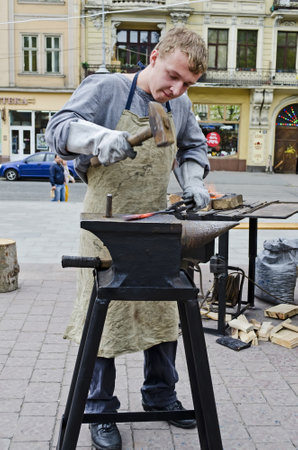 LVOV, UKRAINE - APRIL 28: Blacksmith a master class on the main street in celebrate the Day of the City on April 28, 2013 in Lviv, Ukraineのeditorial素材