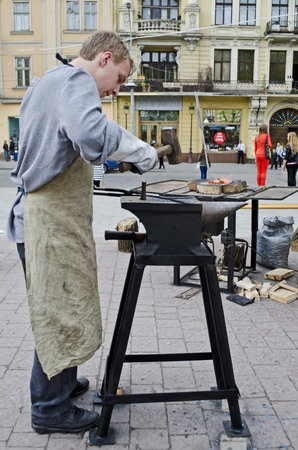 LVOV, UKRAINE - APRIL 28: Blacksmith a master class on the main street in celebrate the Day of the City on April 28, 2013 in Lviv, Ukraineのeditorial素材