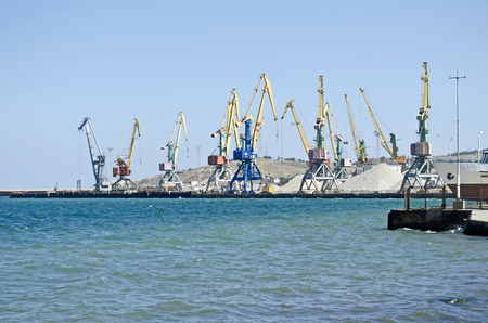 Pier and cranes for unload cargo in Feodosia seaportの写真素材