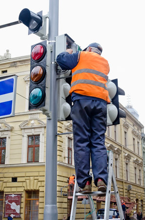 LVOV, UKRAINE - OCTOBER 16: Technical workers in the heart of the city will replace the updated traffic lights on the latest LED on October 16, 2013 in Lviv, Ukraine. のeditorial素材