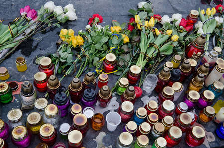 Flowers and candles in honor of those killed in the Maidan in Kiev, lying on the Maidan in Lvovの写真素材