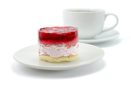Cake with raspberries and a cup of tea, isolated over whiteの写真素材