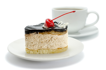 Chocolate cake with cherries and a cup of tea, isolated over whiteの写真素材