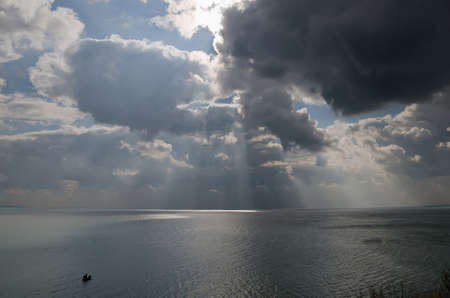 Beautiful seascape - Boat and dramatic clouds over the seaの写真素材