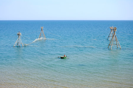 KERCH, CRIMEA, RUSSIA - AUGUST 09: Fishermen on a boat checking fishing nets near Kerch on august 09, 2014 in Kerch, Crimea, Russiaのeditorial素材