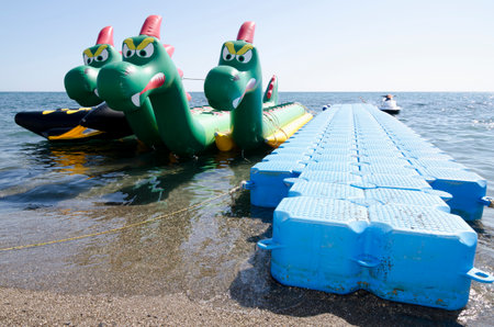 SUDAK, CRIMEA, RUSSIA - AUGUST 24: Attraction on the water in the form of a three-headed dragon on the seafront in the resort town of Sudak on August 24, 2014 in Sudak, Crimea, Russiaのeditorial素材