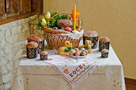 LVOV, UKRAINE - APRIL 30: Easter still life - Easter eggs, Easter cakes, basket, chickens, sausage, candle in the restaurant "Puzata Hata" in the center of Lvov on April 30, 2013 in Lvov, Ukraineのeditorial素材