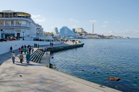 SEVASTOPOL, CRIMEA, RUSSIA - NOVEMBER 04: People walk along the promenade in Sevastopol Bay on November 04, 2014 in Sevastopol, Crimea, Russiaのeditorial素材