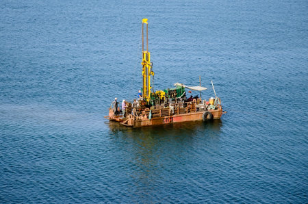 KERCH, CRIMEA, RUSSIA - SEPTEMBER 20: Workers on offshore oil rig take a sample of soil for the construction of a bridge across the Kerch Strait on September 20, 2015 in Kerch, Crimea, Russiaのeditorial素材