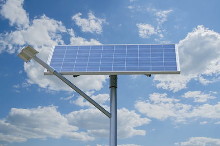 Solar battery generating electricity for street lights against a background of cloudsの写真素材