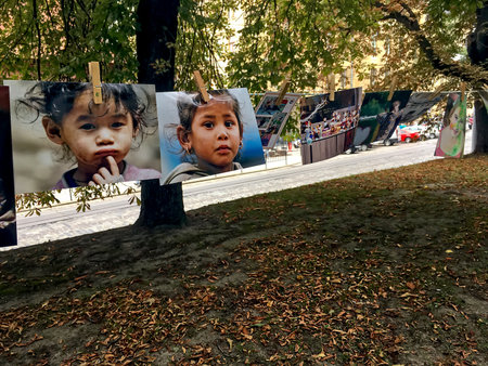 LVIV, UKRAINE - AUGUST 13: Photos of sad faces of children hanging on clothespins during the charity exhibition "Photo on clothespins" in the center of Lviv on August 13, 2017 in Lvov, Ukraineのeditorial素材