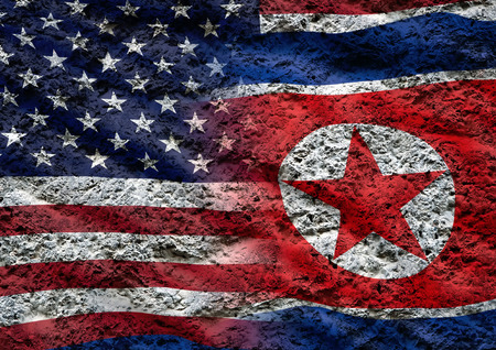 North Korean flag and US flag against the background of the stone textureの写真素材
