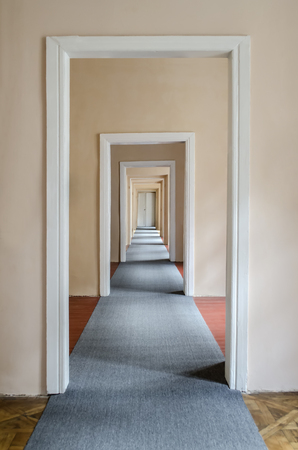 Empty corridor with lots of doors in perspectiveの写真素材